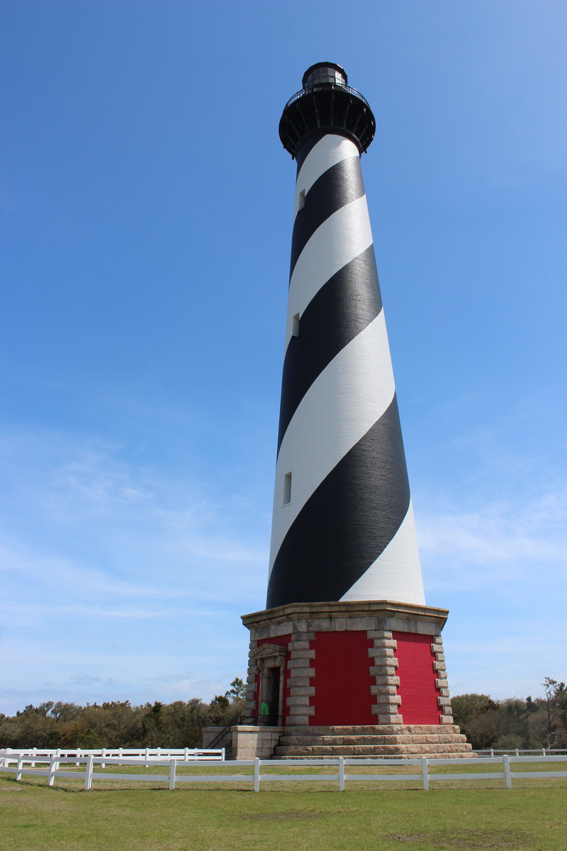 built structure, banks, plant, guidance, building exterior, hatteras, day, nature, lighthouse, outdoors, low angle view, tower, direction, landmark, no people