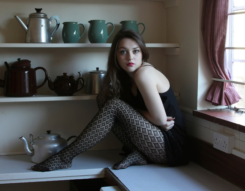 hairstyle, legs, tops, domestic room, portrait, black, young women, sitting, home interior, lifestyles, indoors, sleeveless, fashion, beauty, young adult