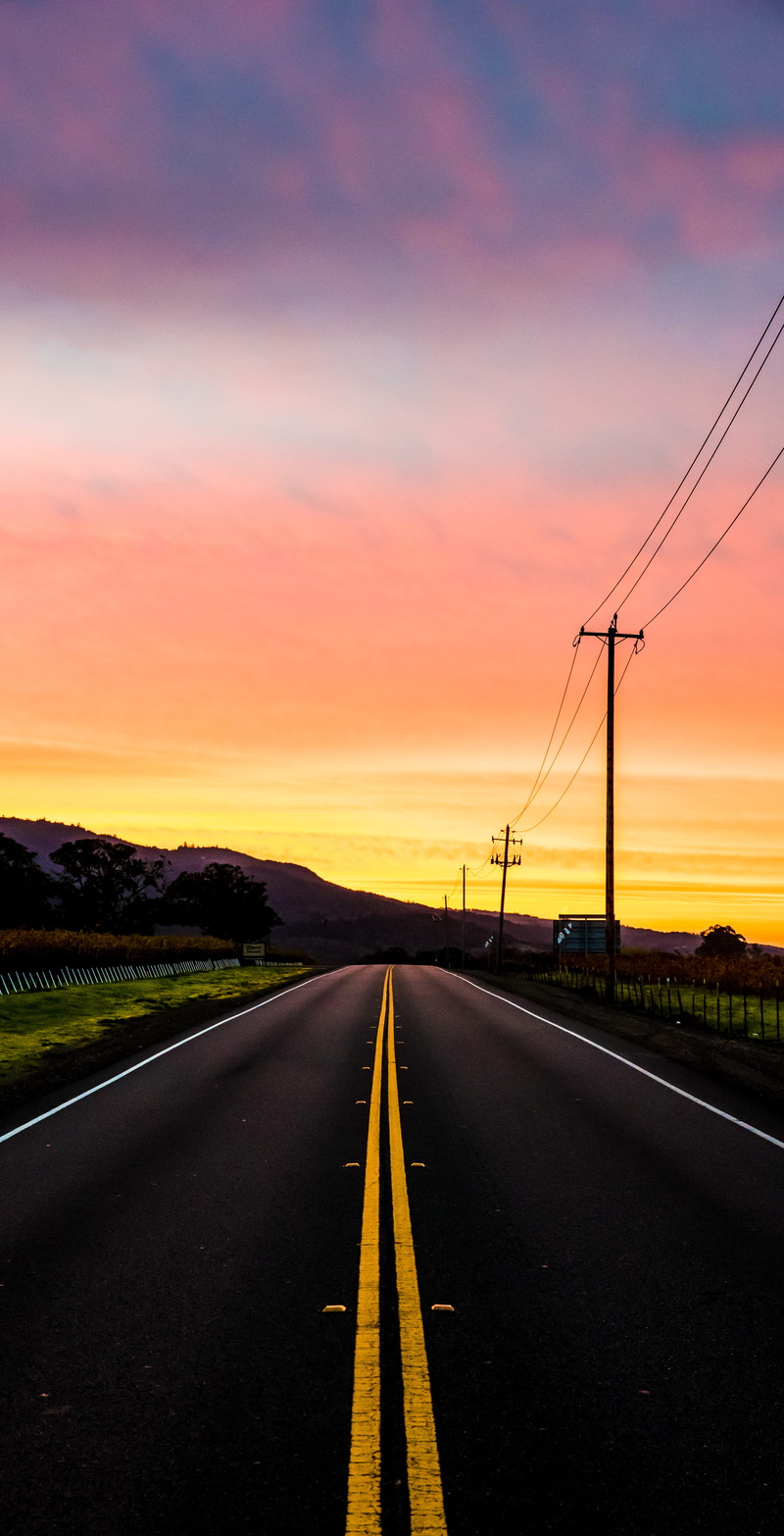 direction, tree, diminishing perspective, orange, sunset, near, vanishing point, landscape, sign, symbol, mountain, asphalt, cable, electricity, sunrise