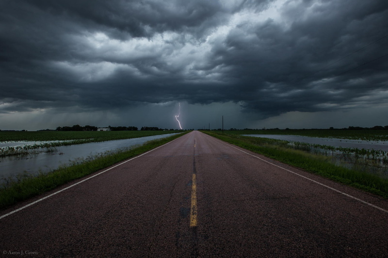 road marking, transportation, cloud - sky, diminishing perspective, no people, vanishing point, outdoors, clouds, road, symbol, the storm, sign, nature