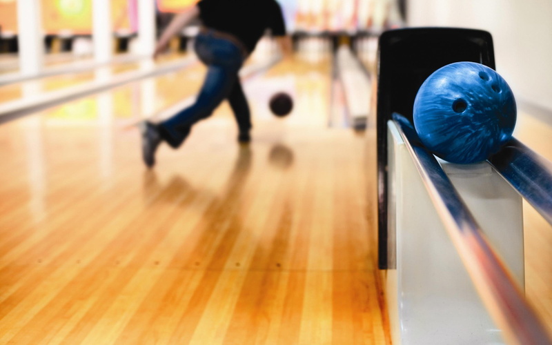 wood, lifestyles, blurred motion, incidental people, indoors, human body part, selective focus, leisure activity, depth of field, motion, bowling, low section