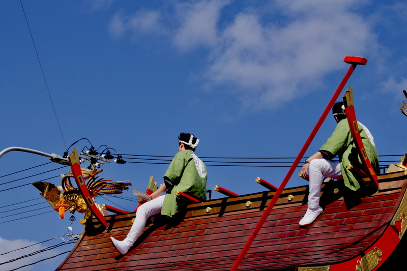transportation, low angle view, day, people, blue, yamagata prefecture, architecture, matsuri, men, asia, sky, real people, outdoors, mode of transportation
