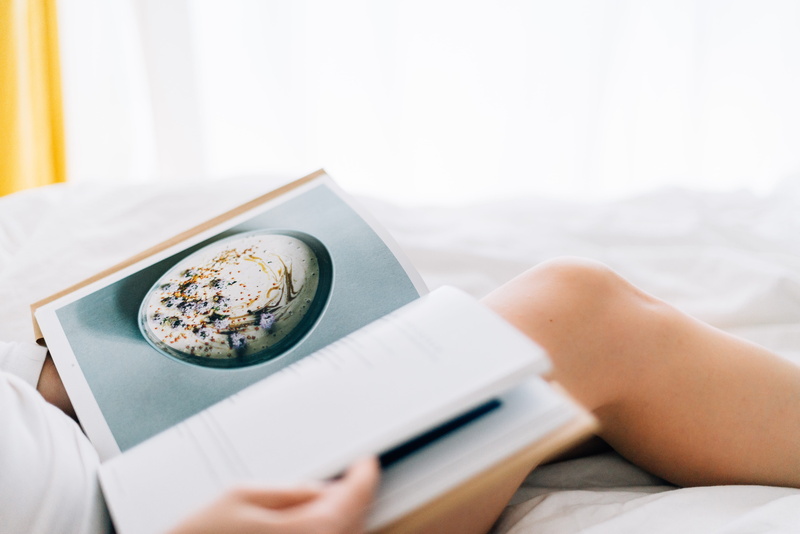 news, easy morning, recipe, magazine, recipe book, food and drink, bed, day, tea cup, read, book, leisure activity, hold, human body part, close-up, sitting