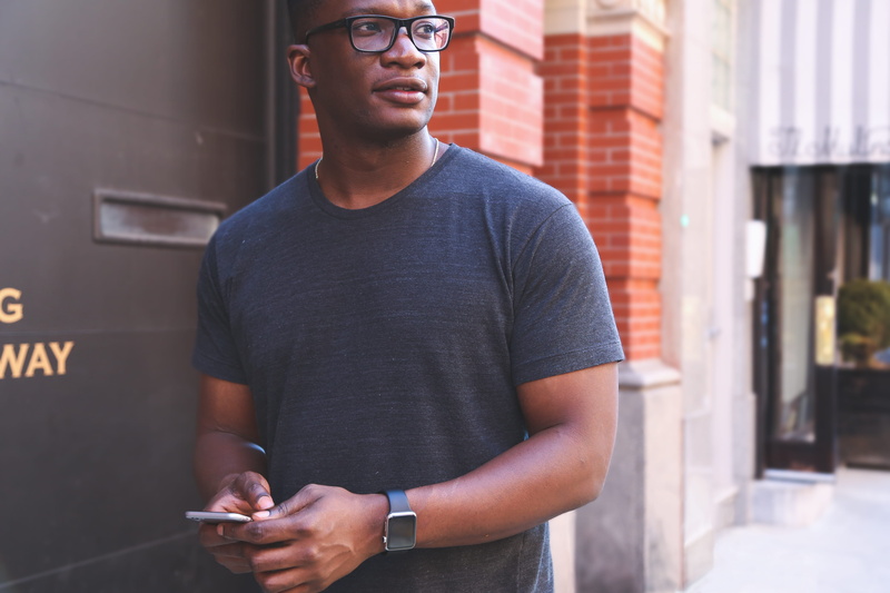 communication, gray, outfit, near, wristwatch, real people, architecture, casual clothing, daylight, glasses, t, technology, smartphone, front view, three quarter length