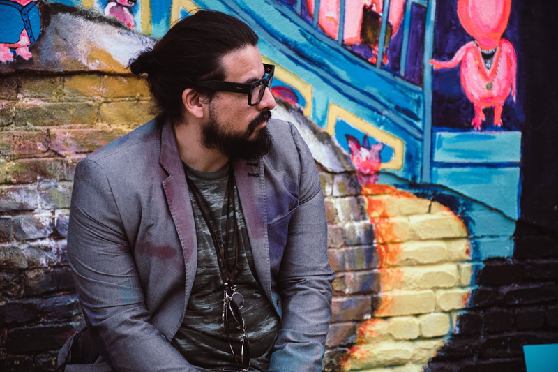 lifestyles, outdoors, wall, 5K, beard, young men, glasses, creativity, three quarter length, murals, coat, graffiti, wall - building feature, adult, one person