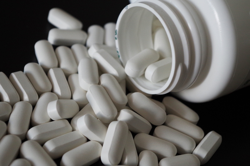 large group of objects, tablets, sick, bottle, wellbeing, nutritional supplement, diet pills, white, spilling, medication, black background, disease, pharmacy