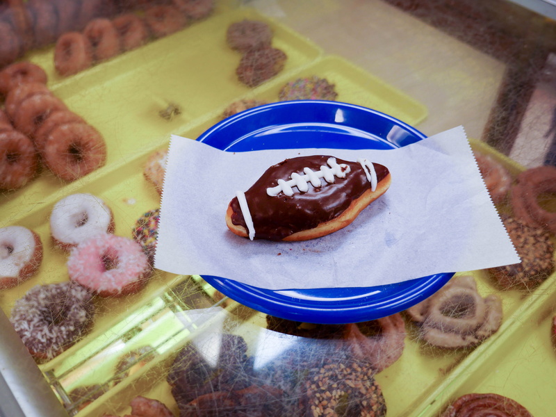 icing, food, bakery, indoors, football, fun, donut, sitting, freshness, unhealthy eating, breakfast, colorful, chocolate, indulgence, snack, pastry, high angle view