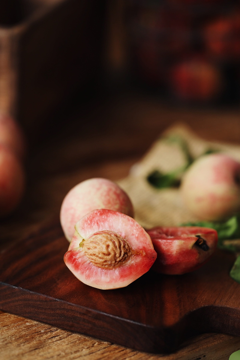 studio shot, cutting board, indoors, 2K, wood - material, table, slice, focus on foreground, fig, wellbeing, ripe, selective focus, no people, food, peaches