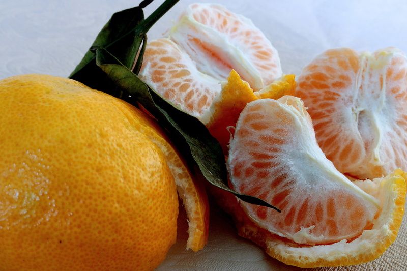 wellbeing, freshness, healthy eating, orange, orange color, indoors, plate, table, tangerine, citrus fruit, high angle view, slice, food, leaf, health