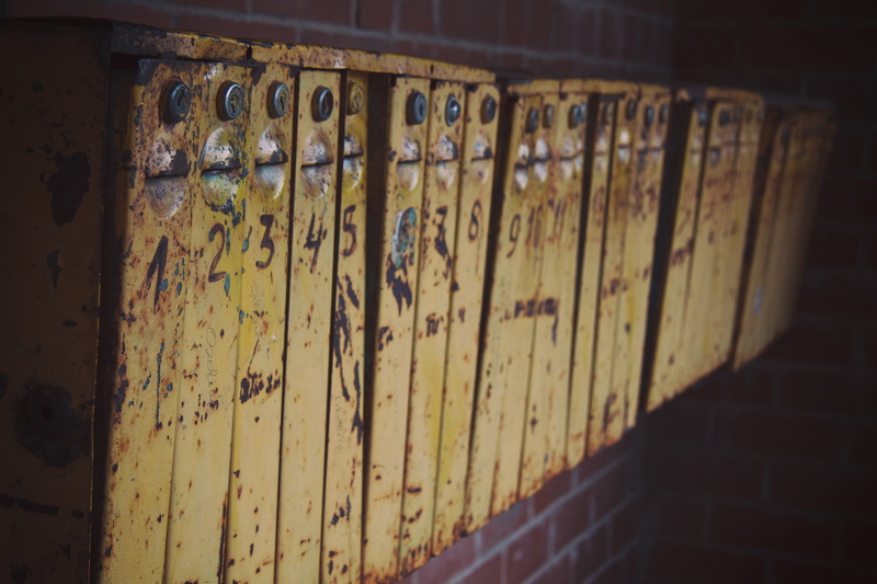 no people, stack, building, vintage, home, selective focus, gray, indoors, old, mailbox, cards, latches, organized, columns, classic, post, numbered, weathered