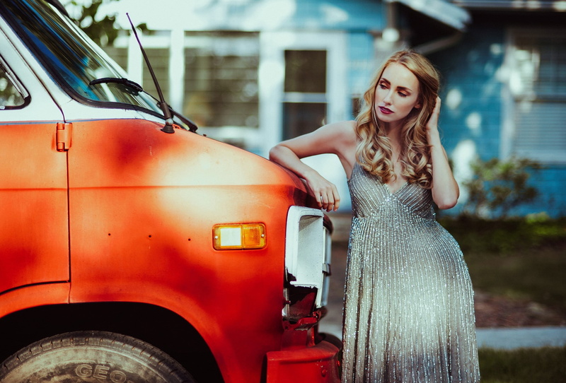 women outdoors, looking away, mode of transportation, lifestyles, focus on foreground, outdoors, standing, three quarter length, hands in hair, transportation