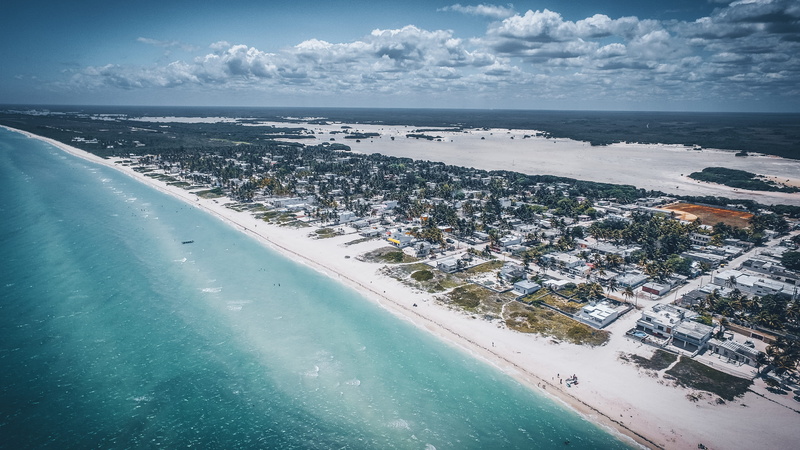 sky, aerial, cloud - sky, beach, building, coast, mexico, island, built structure, ocean, town, architecture, sea, scenery, water, horizon over water, landscape