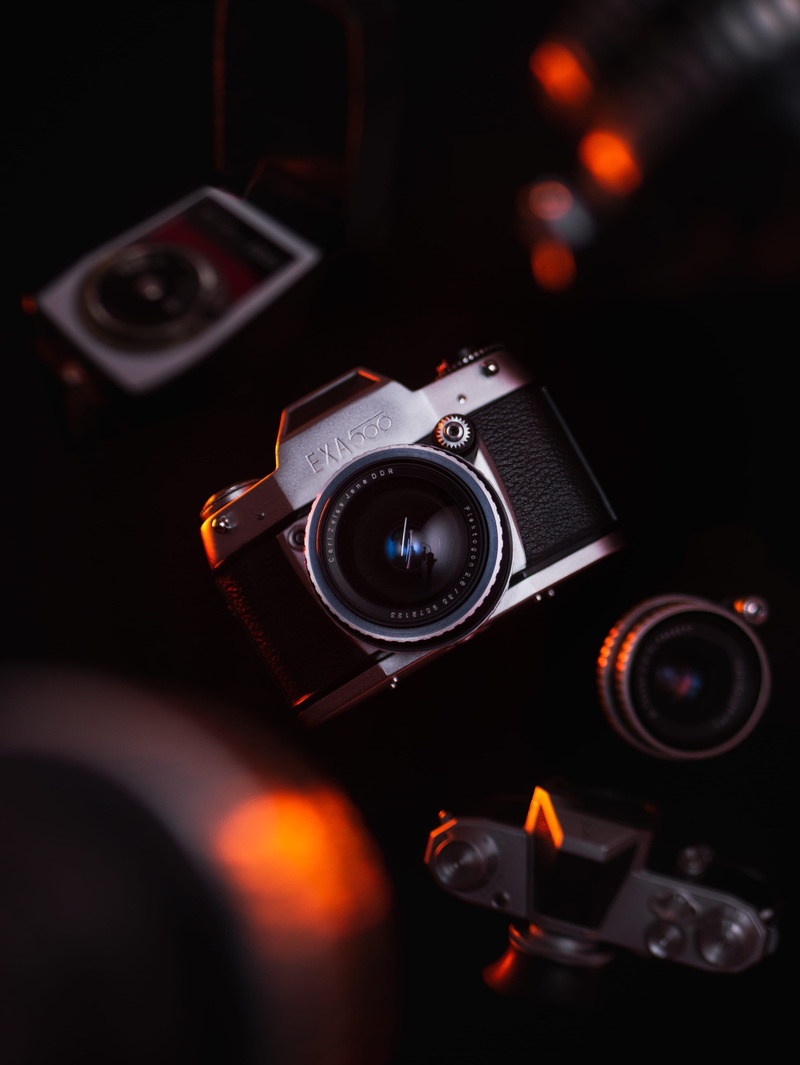 high angle view, studio shot, pc, antique, strap, electronics, lens cap, food, camera lens, close-up, keyboard, hardware, focus on foreground, computer