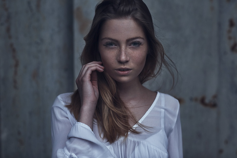 portrait, adult, beauty, contemplation, hairstyle, wall - building feature, looking at camera, lifestyles, real people, long hair, hair, one person, freckles