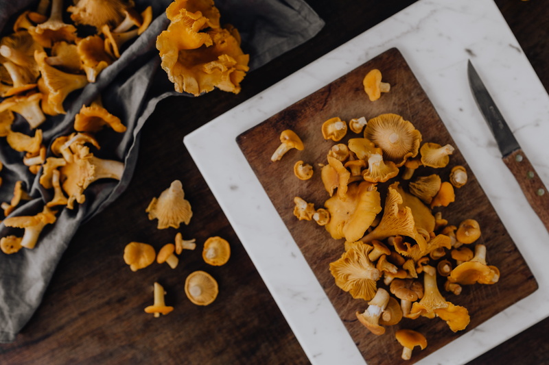 table, yellow mushrooms, wood - material, high angle view, freshness, snack, food, large group of objects, indoors, 5K, wellbeing, mushrooms, walnut, nut