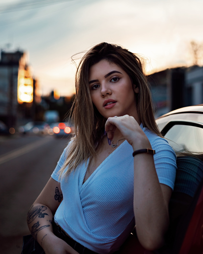 one person, brunette, hairstyle, car, tattooed, women, looking at camera, casual clothing, young adult, transportation, lifestyles, close, vehicle, real people