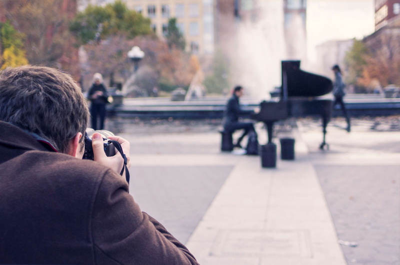 sitting, communication, technology, incidental people, street, street performer, men, activity, taking photo, piano player, people, photography, digital camera