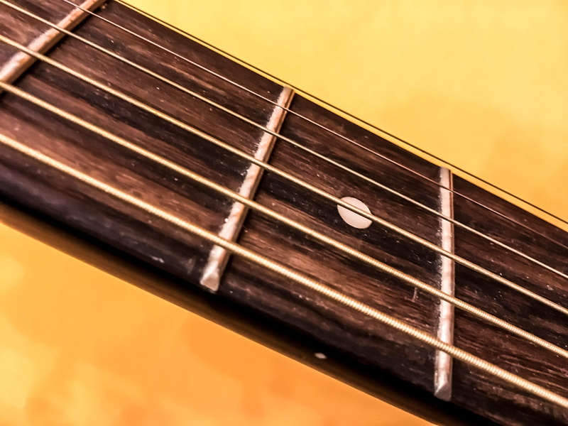 bass guitar, string, poster, piano, label, advertisement, indoors, single object, studio shot, brown, harmonica, still life, plectrum, leisure activities
