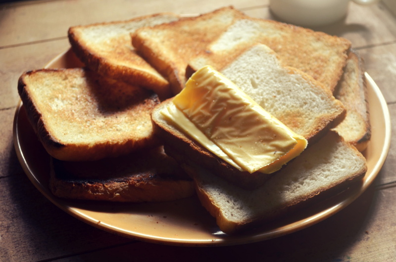 food and drink, slice, still life, close-up, high angle view, melting, butter, white bread, meal, toasted bread, breakfast, toast, spread, snack, dairy product