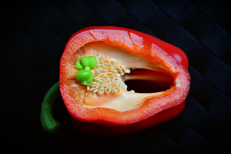 red pepper, wellbeing, paprika, black background, tropical fruit, no people, sliced, 5K, orange color, close-up, food, pepper, food and drink, vegetarian
