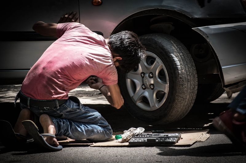 labor, mode of transportation, repairing, kid, men, tire, auto mechanic, mechanic, shopping, land vehicle, motor vehicle, cars, only men, child labor, transportation