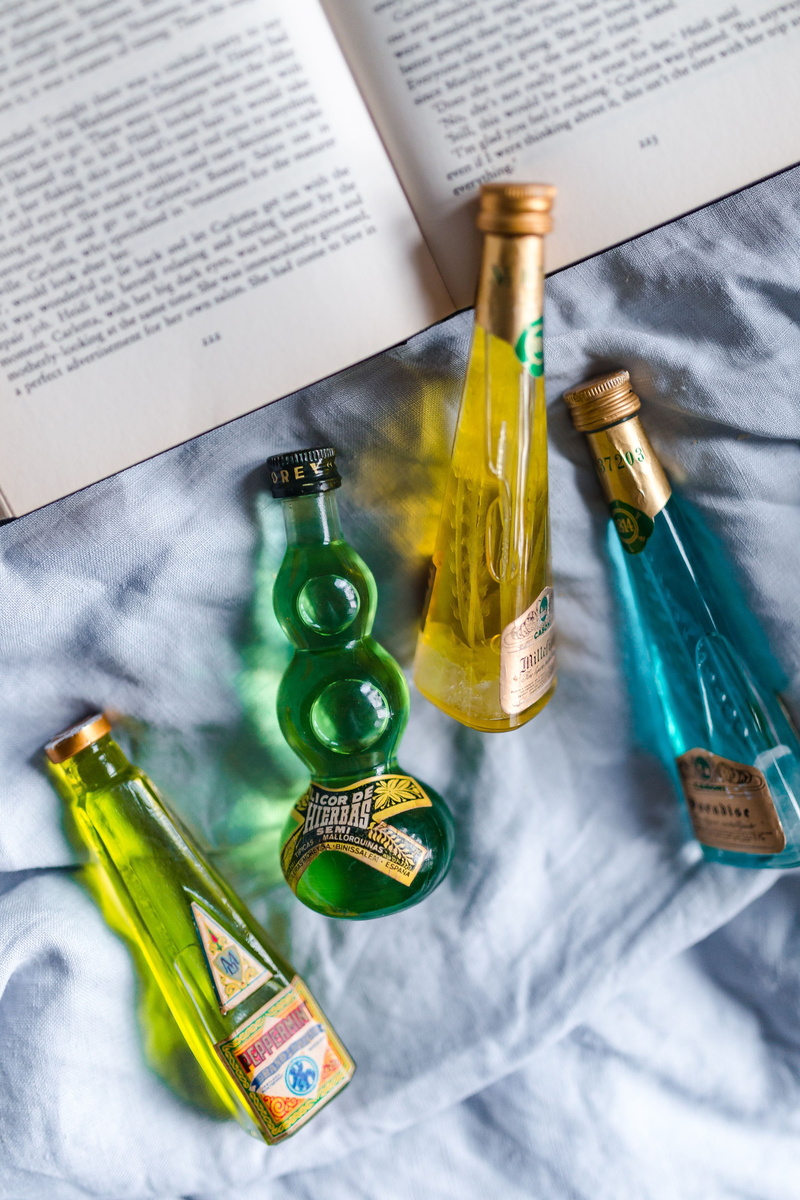 western script, alcohol, paper, publication, education, bed, top view, communication, bottles, drink, bed time, read, text, still life, little, container