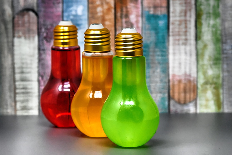 group of objects, light bulbs, 5K, in a row, container, food and drink, bottles, alcohol, decoration, beverages, food, focus on foreground, transparent