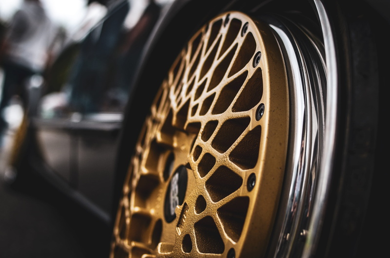 black, 4K, car, close-up, focus on foreground, film reel, wheel, metal, no people, projection equipment, film, shape, camera film, photo, antique, indoors