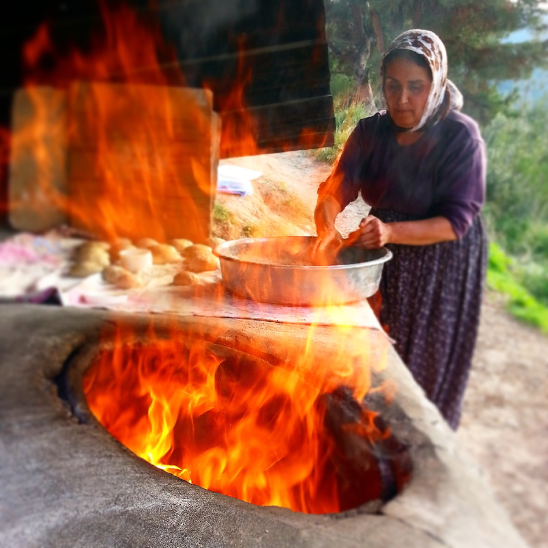 dough, tandoori bread, real people, outdoors, one person, preparation, front view, bread, day, the village woman, burning, nature, flame, adult, fire, motion
