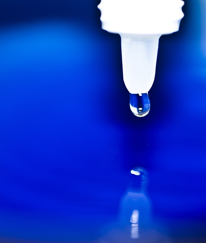 faucet, focus on foreground, eye dropper, photo, electricity, medicine, plastic, studio shot, drop, liquid, illuminated, lighting equipment, colored background