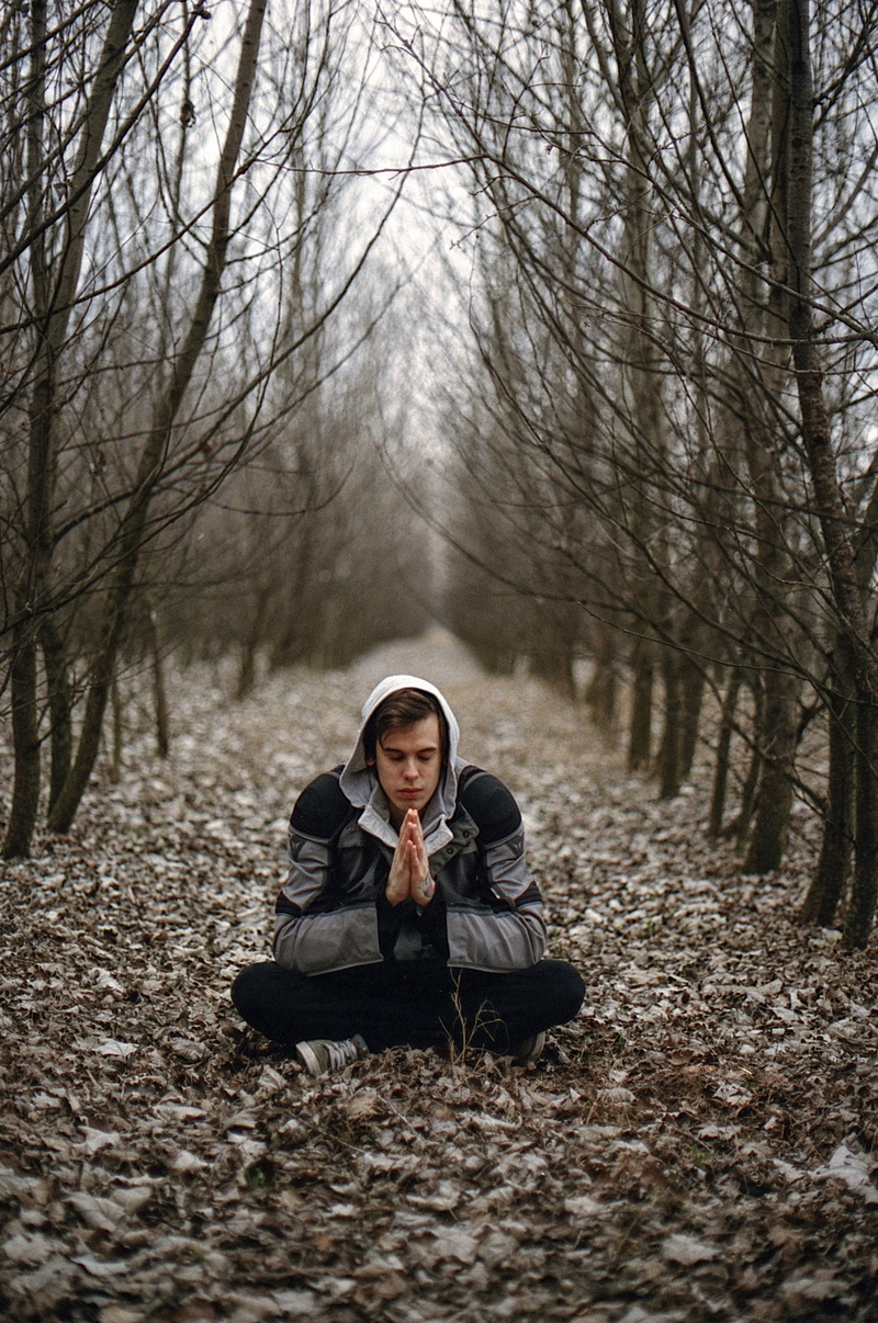 young, male, wholeness, winter, portrait, leisure activity, bare tree, young men, front view, sitting, meditation, one person, woodland, plant, lifestyles