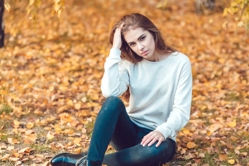 emotion, sadness, outdoors, casual clothing, teenager, teenage girls, depression - sadness, sitting, green, person, young adult, grass, right, leaf, girl