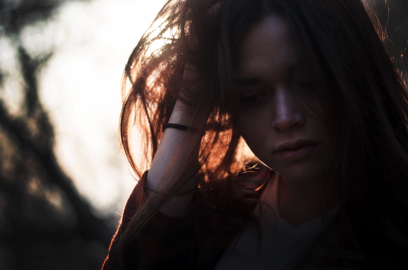 outdoors, hand, girl, woman, women, left, shadow, head, contemplation, forest, beautiful woman, looking, red, headshot, young women, tree, hair, sadness