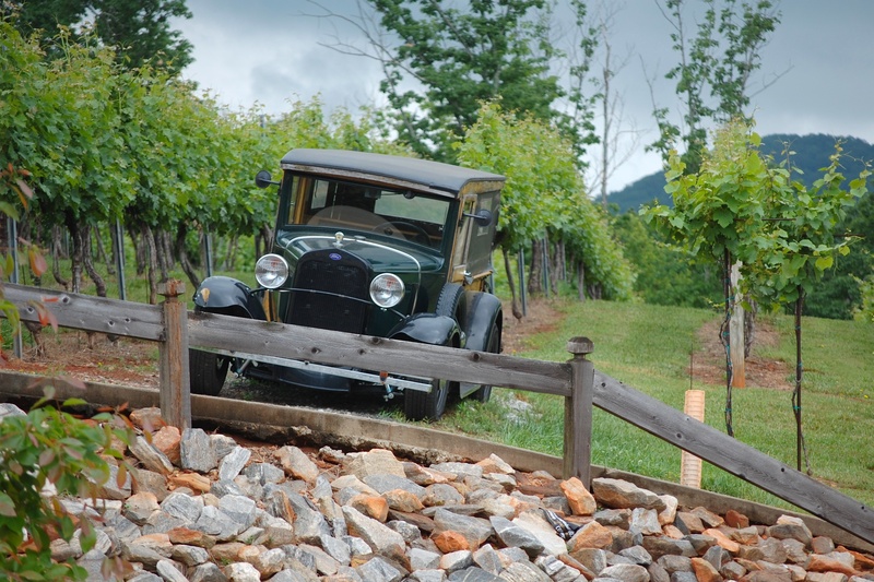 relic, mode of transportation, rock, land Vehicle, outdoors, stone - object, obsolete, solid, landscape, transportation, green color, old car, railroad track