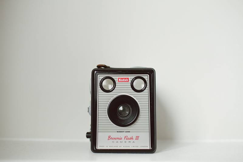 indoors, camera, white background, obsolete, wall, western script, flesh, minimal, white, single object, lens, creativity, brownie, black, photography themes