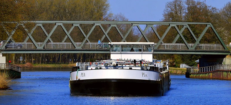 shipping, built structure, mode of transportation, blue, day, travel, human, bridge, waterway, barge, ship traffic, nautical vessel, bridge - man made structure