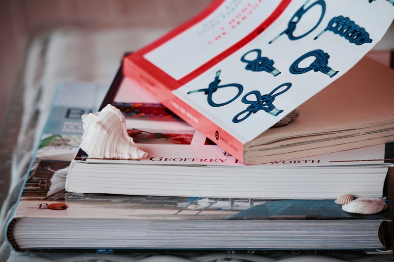 focus on foreground, education, table, document, stack, close-up, summer, no people, shells, knots, creativity, text, books, indoors, wood - material, research