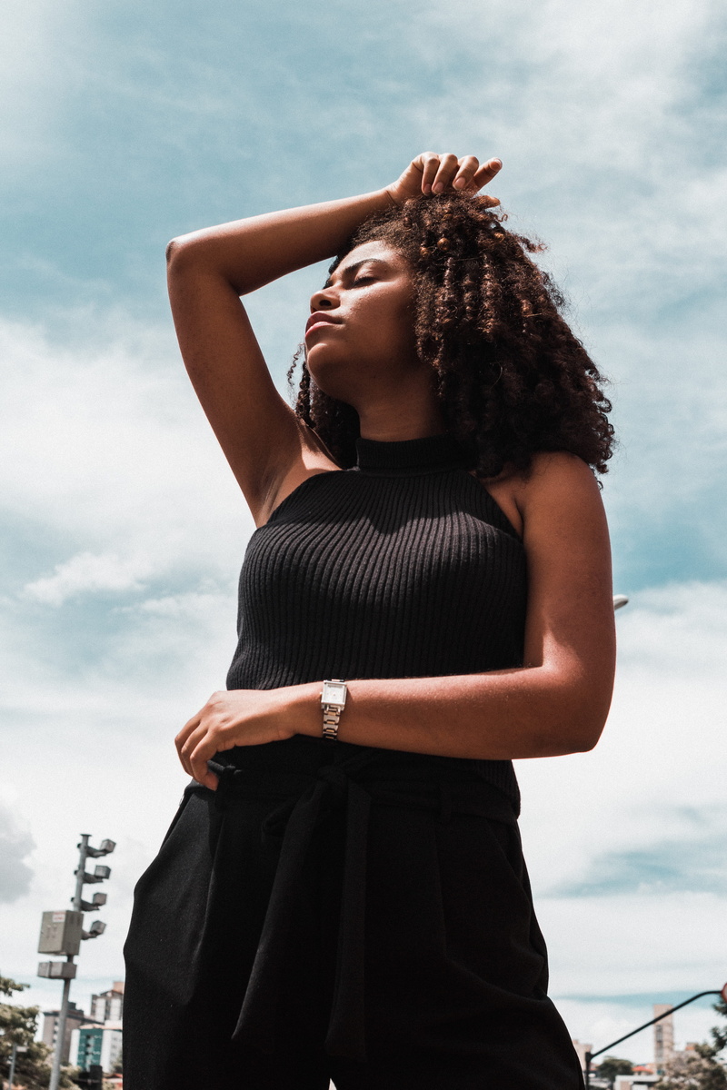three quarter length, apparel, woman, standing, clothing, sleeve, real people, long sleeve, curly hair, casual clothing, dress, person, city, human, lifestyles