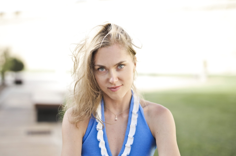 halterneck, hair, one person, wearing, top, park, white, focus on foreground, headshot, looking at camera, hairstyle, blurred background, young adult, blue