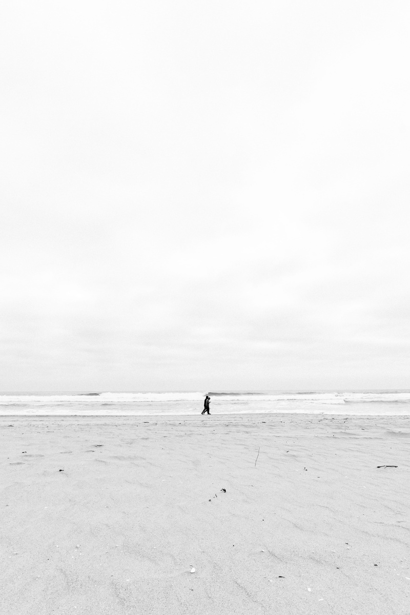 real people, near, tranquil scene, sea, copy space, one person, ocean, person, contrast, water, scenics - nature, coast, scenery, outdoors, soil, sky, tranquility
