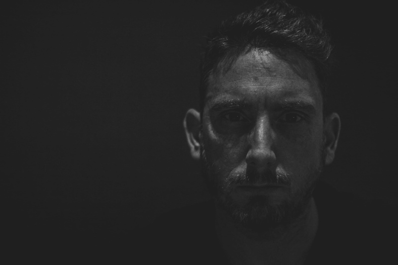headshot, photography, copy space, men, contemplation, human face, indoors, males, 2K, studio shot, facial expression, adult, black background, man, portrait