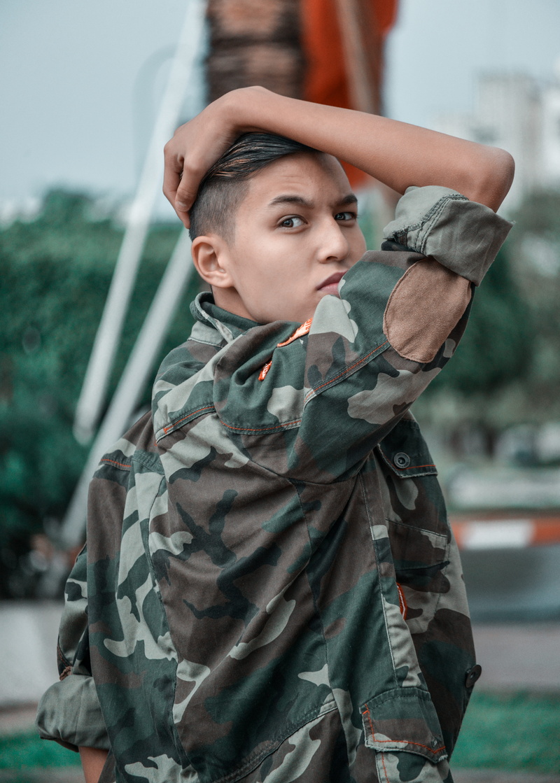 depth of field, portrait, day, boy, front view, photo, looking at camera, young adult, military, posture, clothing, angry, jacket, stylish, wear, boys