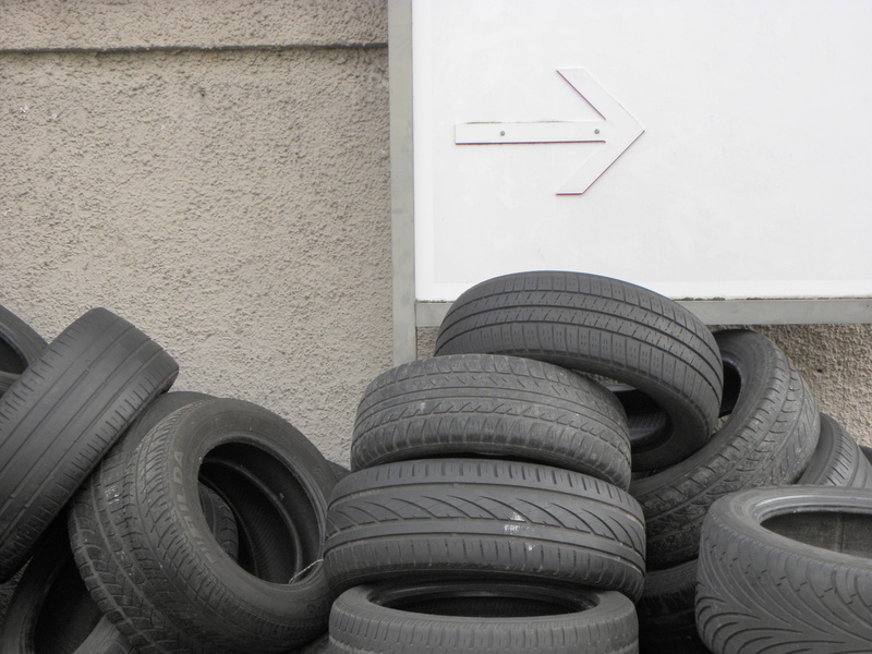 mature, art and craft, stack, black color, profile, auto tires, concrete, disposed of, architecture, built structure, thrown away, wall - building feature