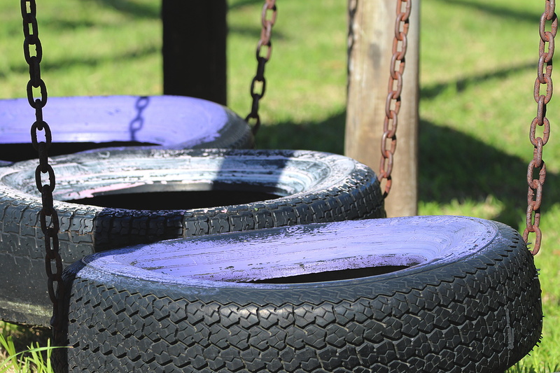 park, front or back yard, no people, chains swing, lonely, focus on foreground, day, architecture, metal, playground, tire swing, outdoors, container, wheel
