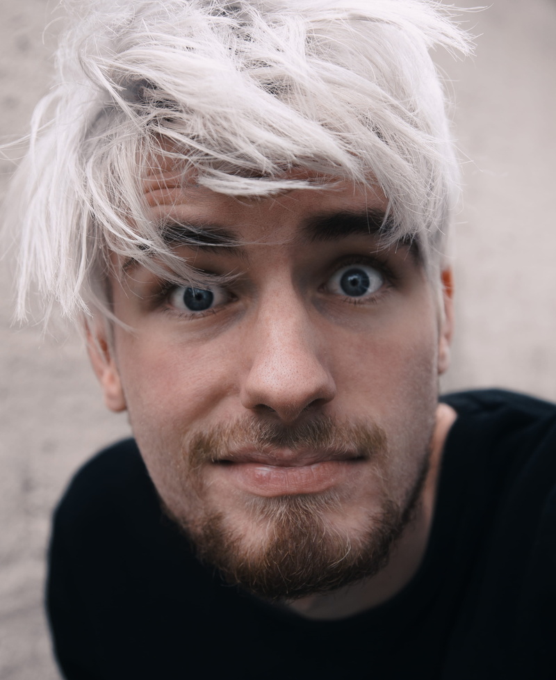 white hair, man, facial hair, hairstyle, one person, men, young adult, close up, lifestyles, focus on foreground, face, real people, expression, hair, males