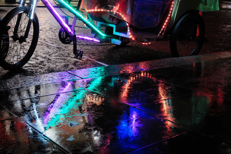 night, city, wet, road, tarmac, multi colored, bike, no people, water, pink color, purple, mode of transportation, arcade game machine, apparel, clothing
