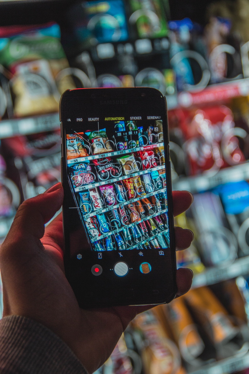 communication, unrecognizable person, human body part, electronics, focus on foreground, shop, phone, machine, smart phone, food, close-up, photographing
