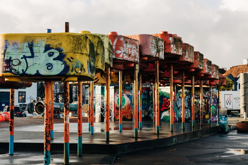 banister, sign, outdoors, amusement park, play area, communication, street art, carousel, art and craft, buildings, multi colored, playground, architecture