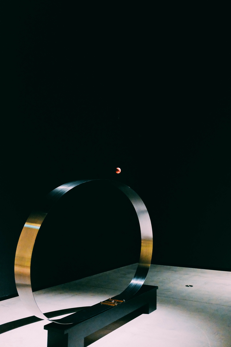 single object, lighting equipment, universe, studio shot, bronze, tabletop, geometric shape, shape, art, table, sculpture, film industry, outer space, droplet