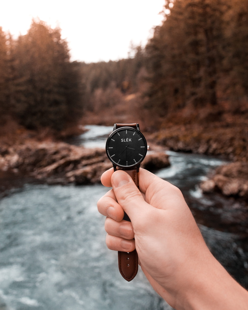 finger, watch, detail, tree, watch face, focus on foreground, analog, forest, leather band, people, human finger, river, personal perspective, human body part